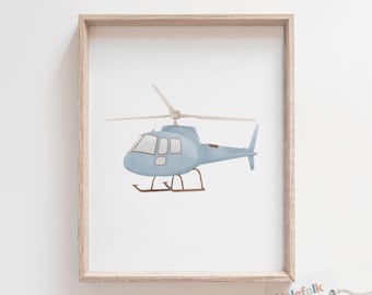 May include: A framed print of a blue watercolor helicopter illustration. The print is on white paper and has a light wood frame. The print is from the company "littlefolk printables" and says "Original Artwork" at the bottom.