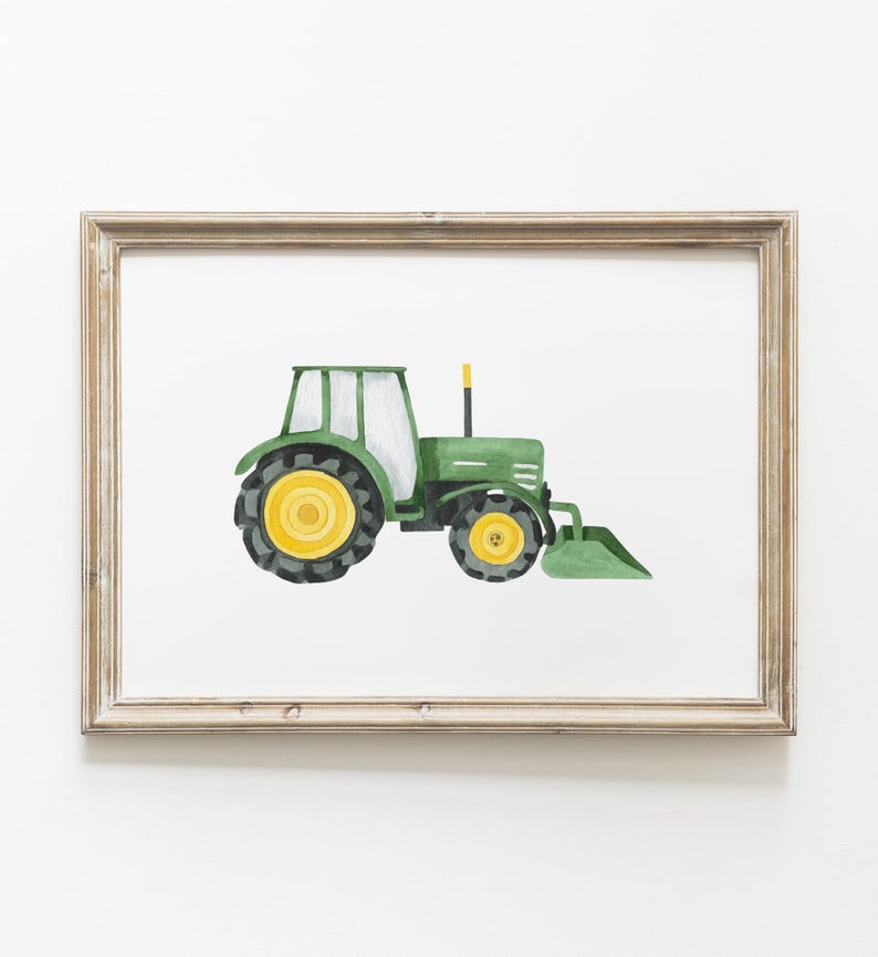 May include: Watercolor illustration of a green tractor with yellow wheels and a front loader, set against a white background. The artwork is framed in a light brown, rustic-style frame, suitable for children's room decor.