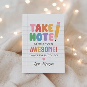 May include: A white notepad with the words "TAKE NOTE" in colorful letters and a yellow pencil illustration. The text "WE THINK YOU'RE AWESOME! THANKS FOR ALL YOU DO!" is also displayed. The notepad is signed "Love, Morgan."
