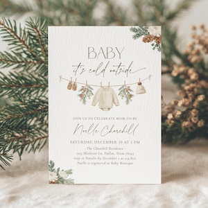 May include: A baby shower invitation with the text "BABY it's cold outside." The invitation features illustrations of baby clothes and winter greenery. The invitation is for Noelle Churchill, Saturday, December 10 at 1 PM.
