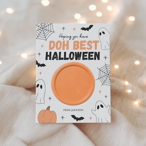 May include: A rectangular white card featuring the text "Hoping you have DOH BEST HALLOWEEN" and "FROM JACKSON". The card is decorated with black illustrations of ghosts, bats, spiderwebs, and a pumpkin, with a circular orange container in the center.