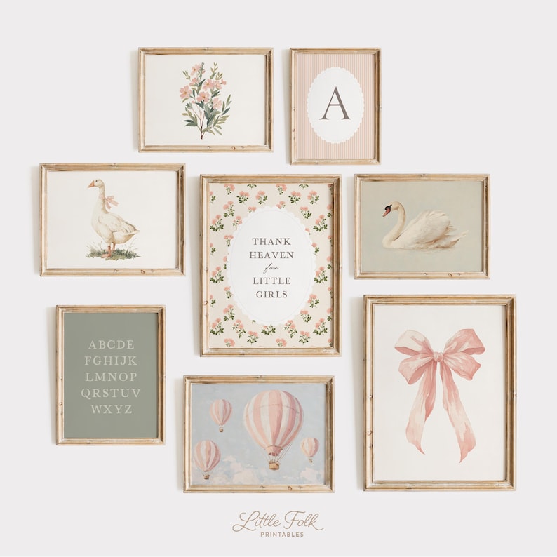 May include: A collection of framed art prints with a vintage aesthetic. The prints feature floral arrangements, a swan, a goose, a pink bow, hot air balloons, an initial, and the text "Thank Heaven for Little Girls". The color palette includes soft pinks, greens, and creams.