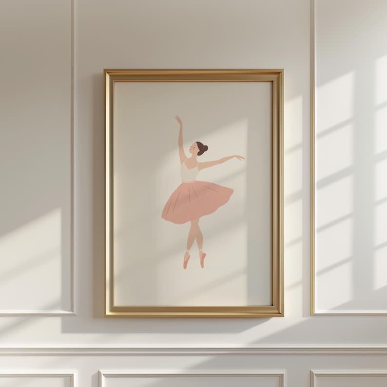 May include: Framed art print featuring a minimalist illustration of a ballerina in a pink tutu and pointe shoes. The dancer is depicted with arms gracefully extended, set against a neutral background. The artwork is encased in a gold frame, adding a touch of elegance.