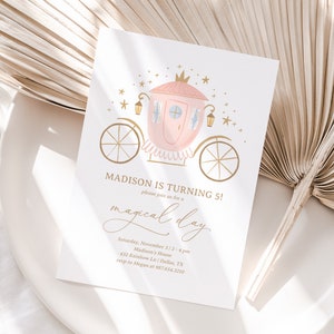 May include: A pink and gold carriage with a crown on top, surrounded by gold stars. The text "MADISON IS TURNING 5!" is written in gold lettering. The text "please join us for a magical day" is written in cursive gold lettering. The text "Saturday, November 3 | 2-4 pm" is written in gold lettering. The text "Madison's House" is written in gold lettering. The text "432 Rainbow Ln | Dallas, TX" is written in gold lettering. The text "rsvp to Megan at 987.654.3210" is written in gold lettering.