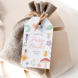 May include: A white thank you tag with a pink and green floral design. The tag says "Thank You Fairy Much!" with the text "With love, Olivia" below. The tag is tied to a brown burlap bag.