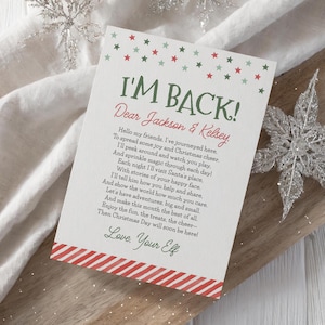May include: A rectangular card with the text "I'M BACK!" in green, and "Dear Jackson & Kelsey" in red. The card has a red and white striped border at the bottom and is decorated with red and green stars.
