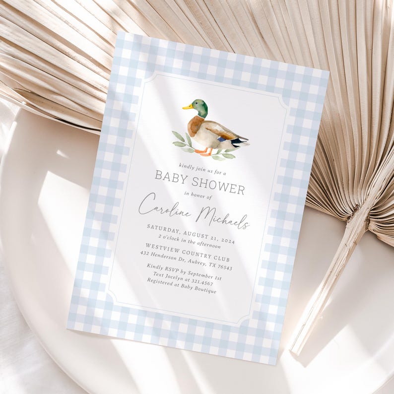 May include: A blue and white gingham baby shower invitation with a watercolor illustration of a duck. The invitation reads "Kindly join us for a Baby Shower in honor of Caroline Michaels. Saturday, August 11, 2024, 2 o'clock in the afternoon, Westview Country Club, 432 Henderson Dr. Aubrey, TX 76543. Kindly RSVP by September 1st, Text Jocelyn at 321.4567, Registered at Baby Boutique."