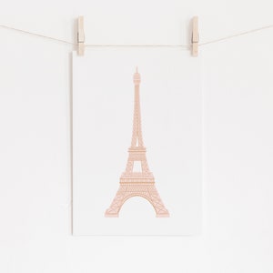 May include: A pink and brown illustration of the Eiffel Tower on a white background.
