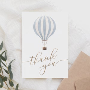 May include: A white card with a blue and white striped hot air balloon illustration and the text "thank you" in brown cursive.