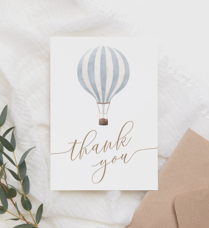 May include: A white card with a blue and white striped hot air balloon illustration and the text "thank you" in brown cursive.