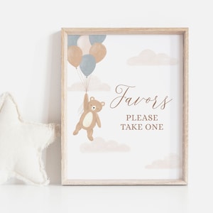 May include: A printable sign with a brown bear holding onto balloons. The balloons are blue, brown, and pink. The sign says "Favors Please Take One".
