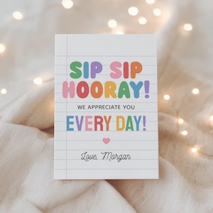 May include: A white notepad with lined paper features the text "SIP SIP HOORAY! WE APPRECIATE YOU EVERY DAY!" in colorful letters. A small pink heart is below the text, and "Love, Morgan" is written at the bottom.