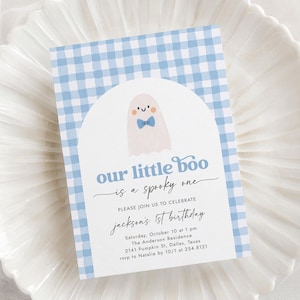 May include: A light blue and white gingham patterned invitation with the text "our little boo is a spooky one". The invitation features a cartoon ghost with a blue bow tie. The invitation is for Jackson's 1st birthday.