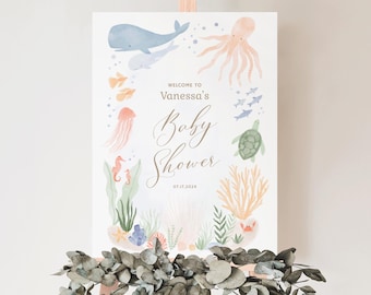 May include: A watercolor illustration of a baby shower welcome sign with an ocean theme. The sign features a whale, octopus, seahorse, turtle, jellyfish, and coral. The text on the sign reads "Welcome to Vanessa's Baby Shower 07.17.2024".
