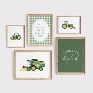 May include: A collection of framed watercolor prints featuring farm-themed illustrations. The prints include green tractors, a combine harvester, and text that reads "We love you 'til the cows come home" and "Long live boyhood". The frames are a light brown color.