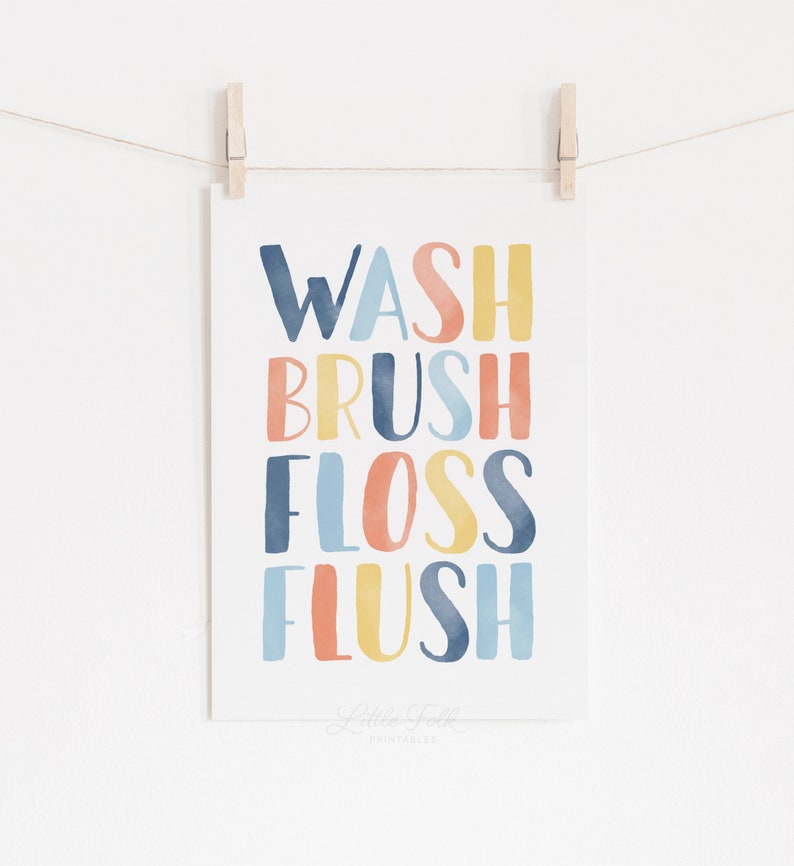 May include: A watercolor print with the words "Wash, Brush, Floss, Flush" in a colorful rainbow pattern. The words are in a stacked vertical format. The print is on a white background and has a subtle watercolor texture.