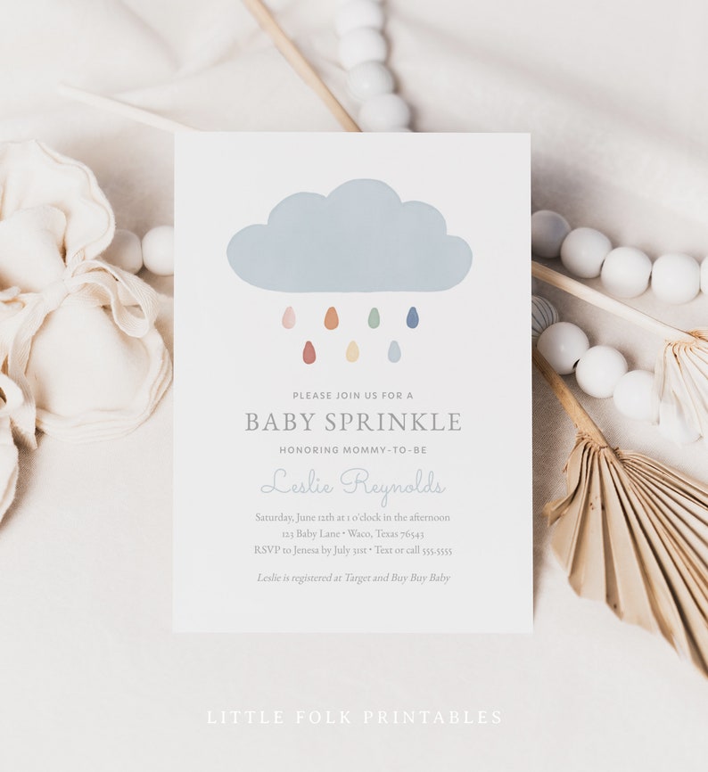 May include: A baby sprinkle invitation featuring a blue cloud and colourful raindrops. The invitation reads "Please join us for a baby sprinkle honouring mommy-to-be Leslie Reynolds".