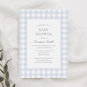 May include: A blue and white gingham baby shower invitation with the text "kindly join us for a BABY SHOWER in honor of Georgia Smith SATURDAY, SEPTEMBER 21, 2024 2 o'clock in the afternoon THE SMITH RESIDENCE 432 Henderson Dr Aubrey, TX 76543 Kindly RSVP by September 1st Text Jocelyn at 987-4321 Registered at Baby Boutique"