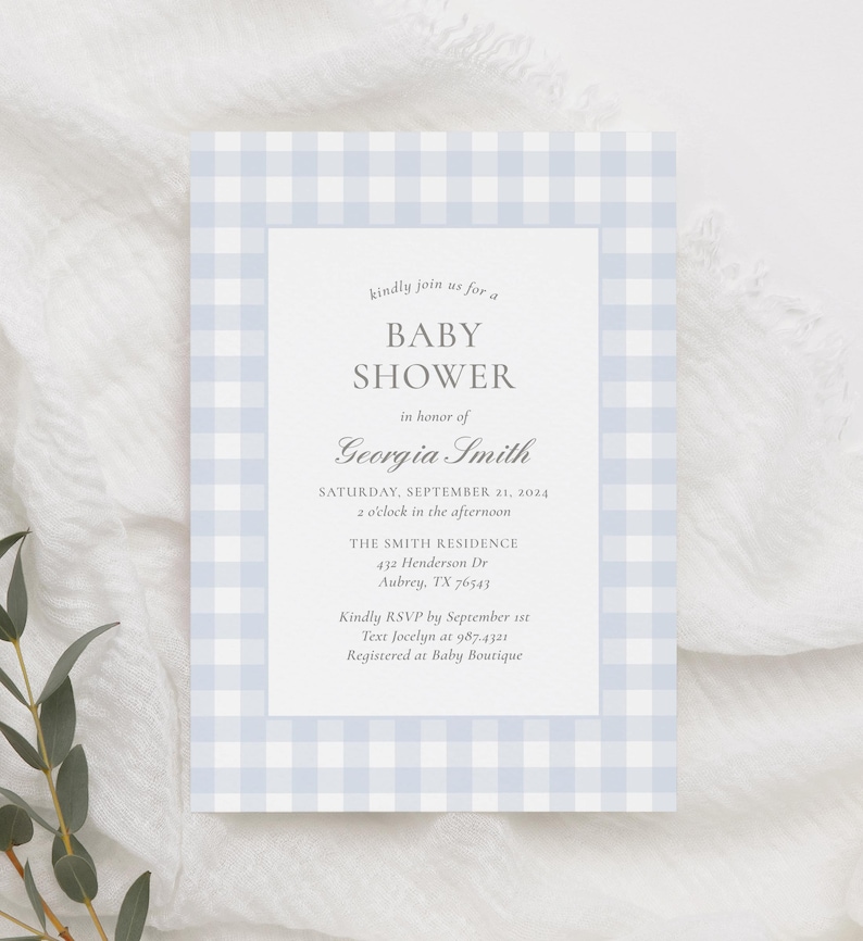 May include: A blue and white gingham baby shower invitation with the text "kindly join us for a BABY SHOWER in honor of Georgia Smith SATURDAY, SEPTEMBER 21, 2024 2 o'clock in the afternoon THE SMITH RESIDENCE 432 Henderson Dr Aubrey, TX 76543 Kindly RSVP by September 1st Text Jocelyn at 987-4321 Registered at Baby Boutique"