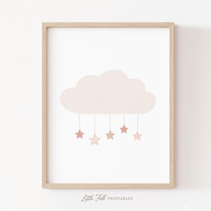 May include: A framed print showing a light beige cloud with five hanging stars in shades of pink and beige. The words "Little Folk Printables" are printed at the bottom of the image.
