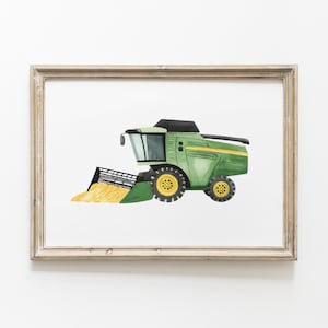 May include: Watercolor illustration of a green and yellow combine harvester, framed in a light brown wooden frame. The farm equipment is depicted in a side view, with a black header and yellow wheels. The artwork is set against a white background.