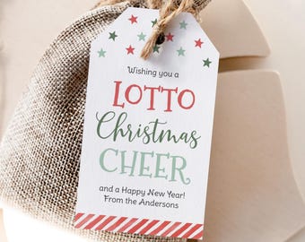May include: A gift tag with the text "Wishing you a LOTTO Christmas CHEER and a Happy New Year! From the Andersons." The tag has red and green stars and a red and white striped border. It is attached to a burlap bag with twine.