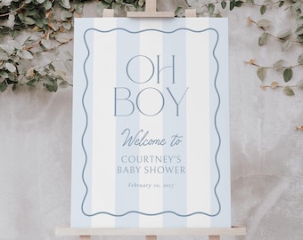 May include: A baby shower welcome sign on an easel. The sign features a light blue and white striped design. The text reads "OH BOY", followed by "Welcome to Courtney's Baby Shower" and the date, all in a serif font.