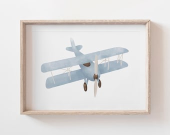 May include: A watercolor illustration of a blue biplane with a brown propeller. The plane is flying in the sky and is framed in a light wood frame.