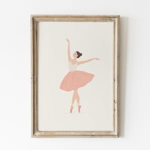 May include: A framed print featuring a ballerina in a graceful pose. The illustration depicts a dancer in a white leotard and a pink tutu, with arms extended. The artwork is set against a neutral background, framed in a light-toned wooden frame.