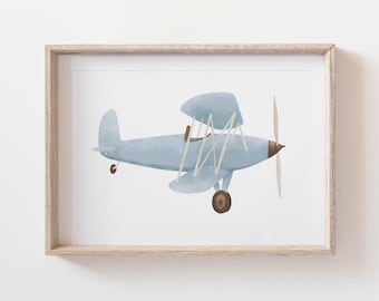May include: A framed print of a light blue biplane with brown propeller and wheels against a white background.