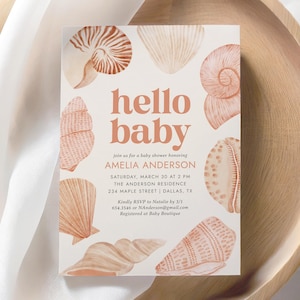 Puede incluir: Una invitación de baby shower blanca con un esquema de color melocotón y rosa. La invitación presenta una ilustración de acuarela de conchas marinas y el texto "hello baby" en una fuente naranja melocotón. La invitación incluye el nombre Amelia Anderson, la fecha y hora de la ducha, la ubicación y la información de RSVP.