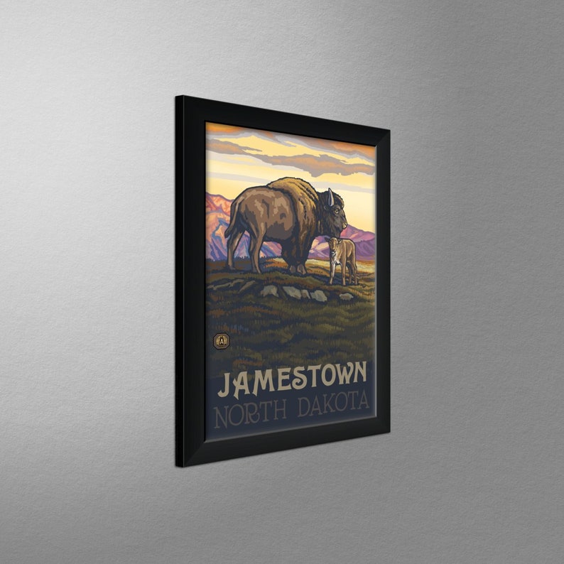 May include: A vintage travel poster featuring a brown bison and a calf standing in a grassy field with mountains in the background. The poster has the text "Jamestown, North Dakota" at the bottom.