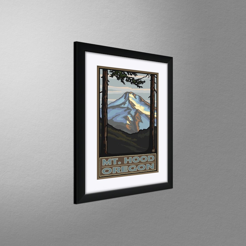 May include: A framed vintage travel poster featuring a stylized illustration of Mount Hood, Oregon. The poster is in a black frame and has a blue, white, and brown color scheme. The text "MT. HOOD OREGON" is printed at the bottom of the poster.