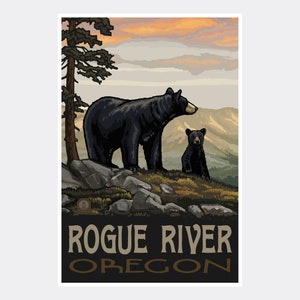 May include: A vintage travel poster featuring a black bear and cub standing on a rocky mountaintop. The sky is a vibrant orange and pink sunset. The text "Rogue River Oregon" is printed in brown letters at the bottom of the poster.
