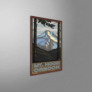 May include: A vintage-style metal sign featuring a stylized illustration of Mount Hood, a snow-capped mountain in Oregon. The sign has a brown background with a red border and the text "MT. HOOD OREGON" in blue and white lettering.
