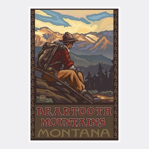 May include: A vintage travel poster featuring a hiker in a plaid shirt and a hat, sitting on a rock overlooking a mountain range. The poster is titled "Beartooth Mountains Montana" with a brown background and a gold border.