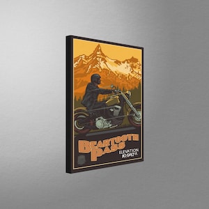 May include: A vintage-style poster featuring a motorcycle rider driving through a mountain pass. The poster is titled "Beartooth Pass" with the text "Elevation 10,947 ft."