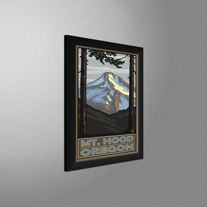 May include: A framed vintage travel poster featuring a stylized illustration of Mount Hood, Oregon. The poster is in a black frame and has a blue, white, and brown color scheme. The text "MT. HOOD OREGON" is printed at the bottom of the poster.