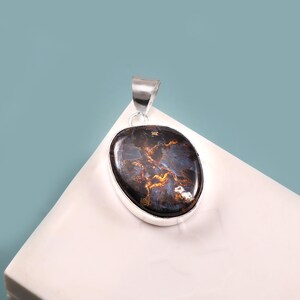 May include: A set of three ceramic mugs with a speckled, matte finish. The mugs are in shades of cream, light brown, and dark brown. Each mug has a simple, minimalist design and a rounded handle.