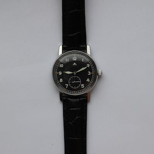May include: A black-faced wristwatch with white numerals and a silver case. The watch has a black leather band.
