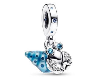 May include: A silver charm featuring a crab design with a blue and white shell. The crab has two blue gem eyes and is adorned with clear crystals. The charm has a loop at the top with blue gems, designed to be added to a bracelet or necklace.