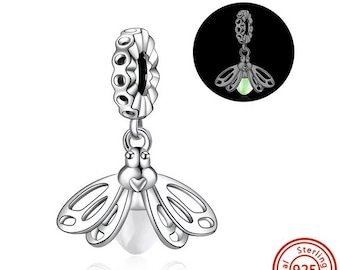 May include: A sterling silver charm with a firefly design. The charm features a detailed firefly with openwork wings and a glowing, round body. The charm is attached to a beaded loop for easy attachment to a bracelet or necklace. A small, round, silver seal with the text "Sterling 925" is in the bottom right corner.
