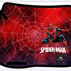 May include: A black-edged saddle pad featuring a red background with a white spiderweb design. The image includes a crouching Spider-Man graphic and the text "SPIDER-MAN". A small logo is visible at the bottom.