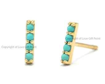 May include: A pair of gold bar earrings with turquoise stones.  Copyright of Love Gift Point.