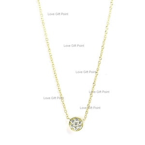 May include: A delicate gold chain necklace with a small round pendant set with sparkling white cubic zirconia stones.