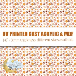 Puede incluir: Un diseño floral con pequeñas flores naranjas, marrones y blancas. El texto "UV PRINTED CAST ACRYLIC & MDF" y "1/8" / 3 mm de grosor, diferentes tamaños disponibles" están presentes. El logotipo de Dream Cut CRAFTS está en la esquina inferior izquierda.