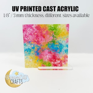 Puede incluir: Un diseño abstracto colorido impreso en una lámina de acrílico fundido impreso UV de 3 mm de grosor. La lámina está sobre un soporte de acrílico transparente. El texto "Dream Cat CRAFTS" es visible en la esquina inferior izquierda de la imagen.