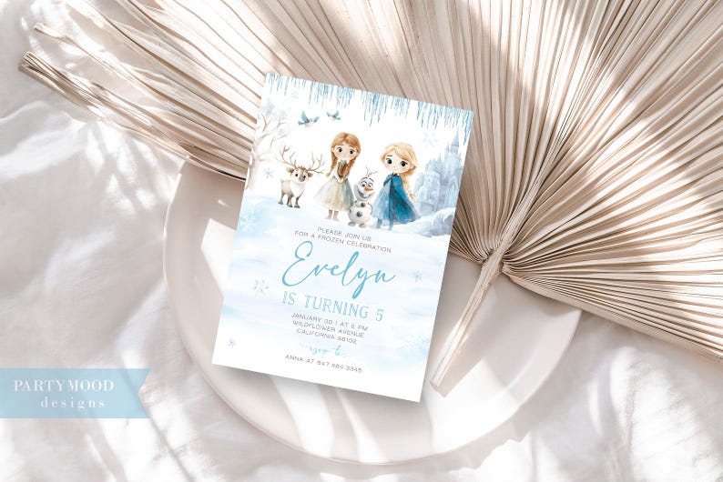 K&ouml;nnte beinhalten: Eine blaue und wei&szlig;e Einladungskarte mit einer Aquarell-Illustration von zwei M&auml;dchen und einem Rentier. Der Text auf der Karte lautet "Bitte schlie&szlig;en Sie sich uns zu einer Frozen-Feier an. Evelyn wird 5 Jahre alt. 10. Januar um 16:00 Uhr Wildflower Avenue Kalifornien 91214 RSVP Anna unter 847 484 5306".