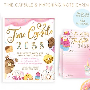 May include: A pink and blue time capsule sign with gold lettering that says "Time Capsule 2038". The sign has a watercolor background with sprinkles and donuts. There are also three matching note cards with the same design.