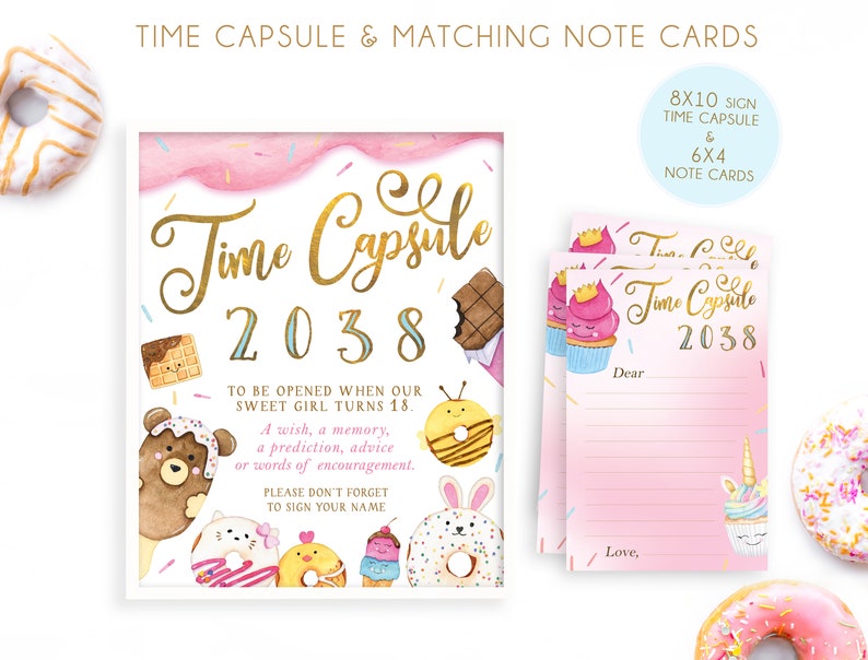 May include: A pink and blue time capsule sign with gold lettering that says "Time Capsule 2038". The sign has a watercolor background with sprinkles and donuts. There are also three matching note cards with the same design.